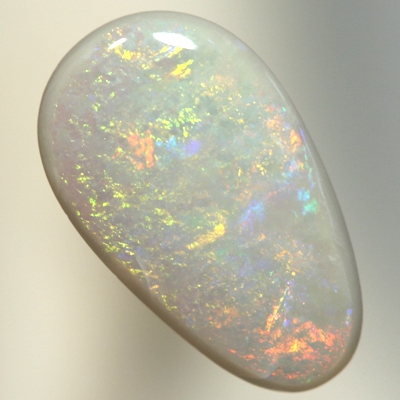 SOLID SEMI BLACK OPAL Orange and green move gently over a medium dome